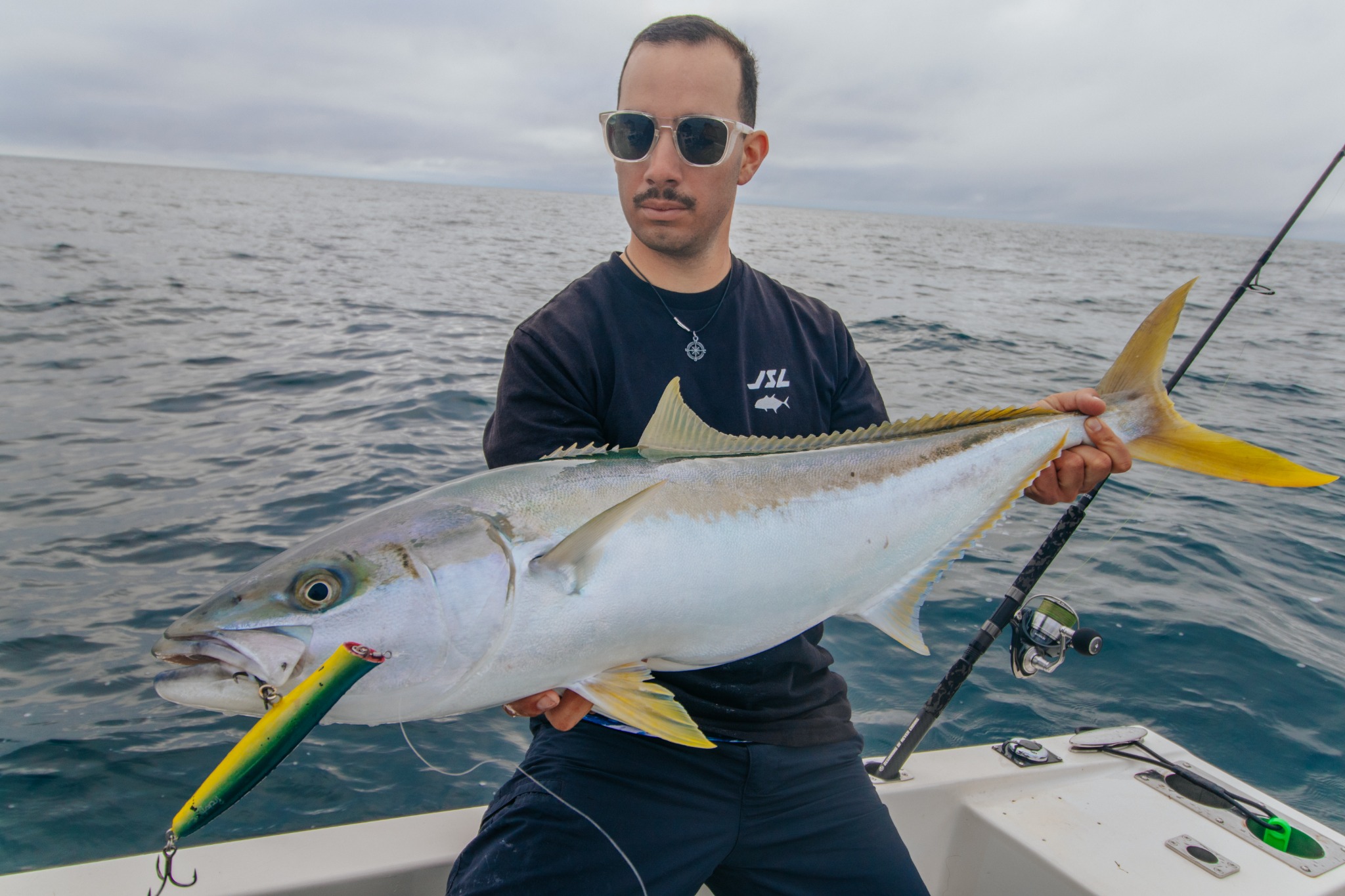 Angler holding a kingfish with a JSL lure